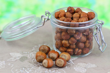Whole hazelnuts in vintage glass jar, close up