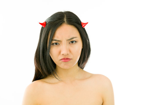 Devil side of a young naked Asian woman looking sad