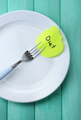 Note paper with message  attached to fork,