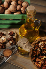 Walnut oil and nuts on wooden table