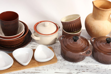 Different tableware on shelf, isolated on white