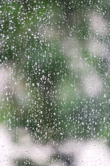 Rain water drops on window glass