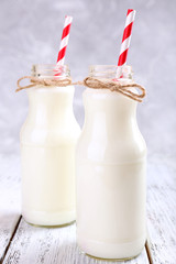 Bottles of milk on wooden table