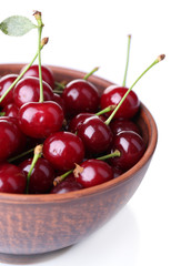 Cherries in color bowl isolated on white