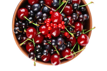 Summer berries in color bowl isolated on white