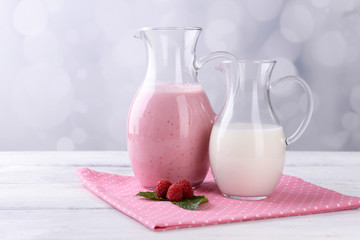 Glass jug of milk cocktail with raspberry taste