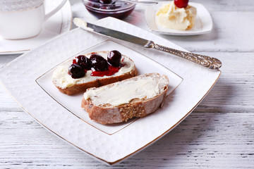 Fresh bread with cherry jam and homemade butter