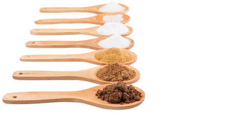 Various type of sugar on wooden spoon over white background