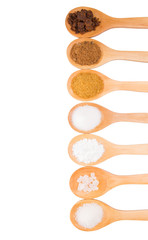 Various type of sugar on wooden spoon over white background