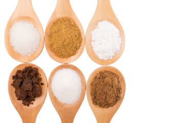 Various type of sugar on wooden spoon over white background