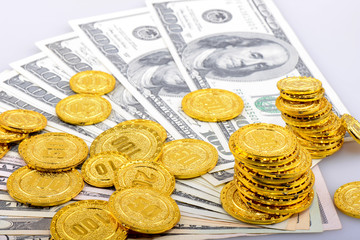 Gold coins and dollar banknotes