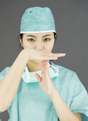 Asian female surgeon showing timeout signal