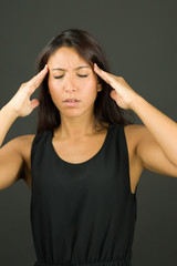 Upset young woman suffering from headache