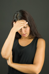 Upset young woman suffering from headache