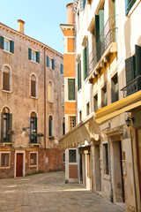 Fototapeta na wymiar House on a narrow street in the Italian city of Venice, Italy