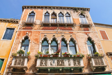 Picturesque Italian house with flowers on the balconies