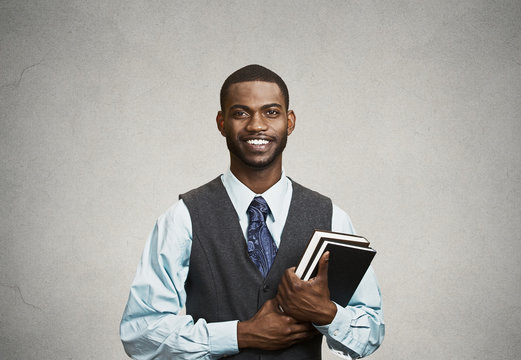 Portrait confident young man, student holding books