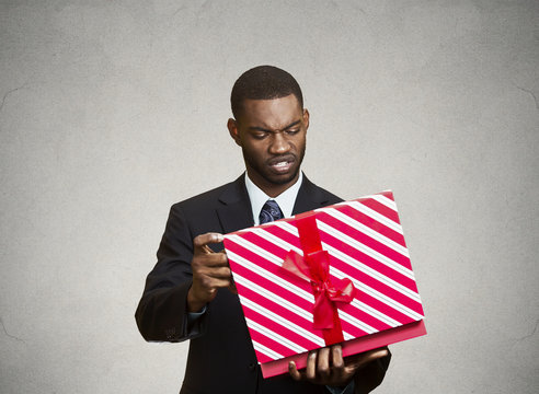 Unhappy man, displeased with new gift he received