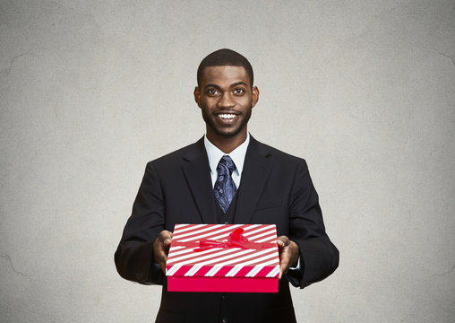 Happy businessman giving gift box to someone