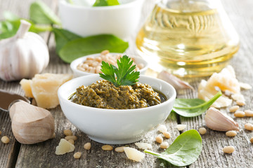 pesto sauce in a bowl and ingredients