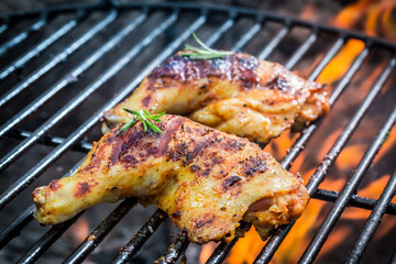 Roasted chicken legs on the grill with fire
