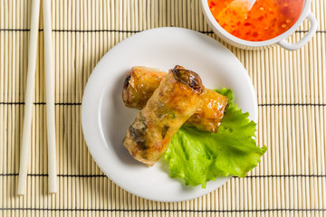 Close-up on spring rolls with sweet and sour sauce