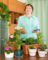 Mature woman with plants at home