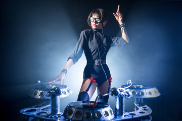 DJ girl playing in a club on vinyl