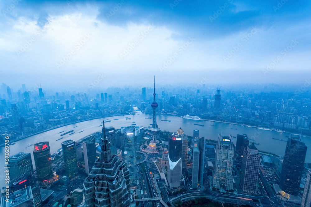 Wall mural shanghai at dusk with cloudy sky