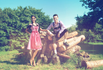 Couple in Bavarian clothes posing in countryside