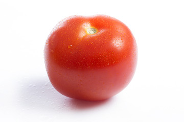 A single red tomato on a white background
