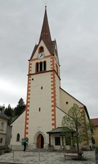 Fototapeta na wymiar high Bell Tower of the Church of the city of Mauthen, austria