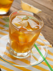 Iced tea with lemon slices, selective focus