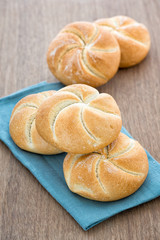 Homemade fresh bread buns  on old wooden table, selective focus