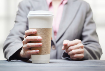 Business woman with a tumbler of coffee