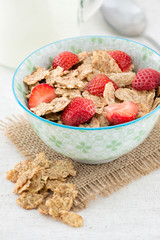 Morning breakfast with cornflakes and fresh stawberry