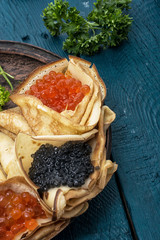 pancakes stuffed with red and black caviar