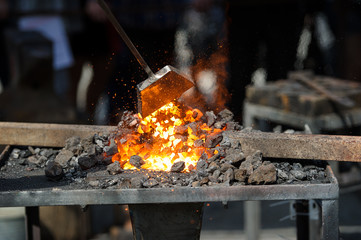 Old fashioned blacksmith furnace with burning coals