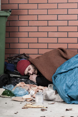 Homeless resting on the pavement