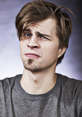 Fototapeta premium Studio portrait of a suspicious young man