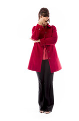 Upset Indian young woman with her head in hands on white