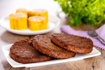 Beefsteak with corncob - Frikadelle mit Maiskolben