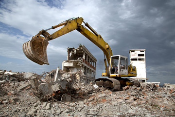Bulldozer removes the debris from demolition of old buildings