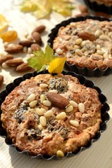 Small tarts in metal shapes, shells filled with nuts .