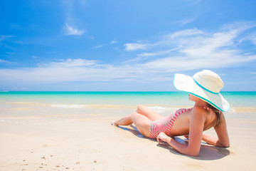 Fototapeta na wymiar long haired woman in bikini and straw hat bikini on tropical