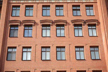 Fototapeta na wymiar Front view of brick wall contemporary apartment building