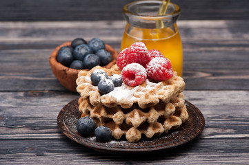 Waffles with berries and honey. Breakfast