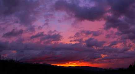 Fototapeta na wymiar Purple sunset in the mountains, dramatic sky, purple sunset, Lag