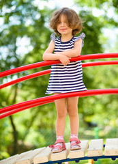 Cute little girl is playing in playground