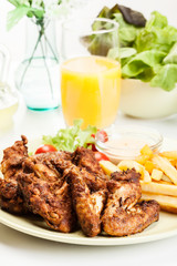 Chicken wings with fries french and spicy sauce
